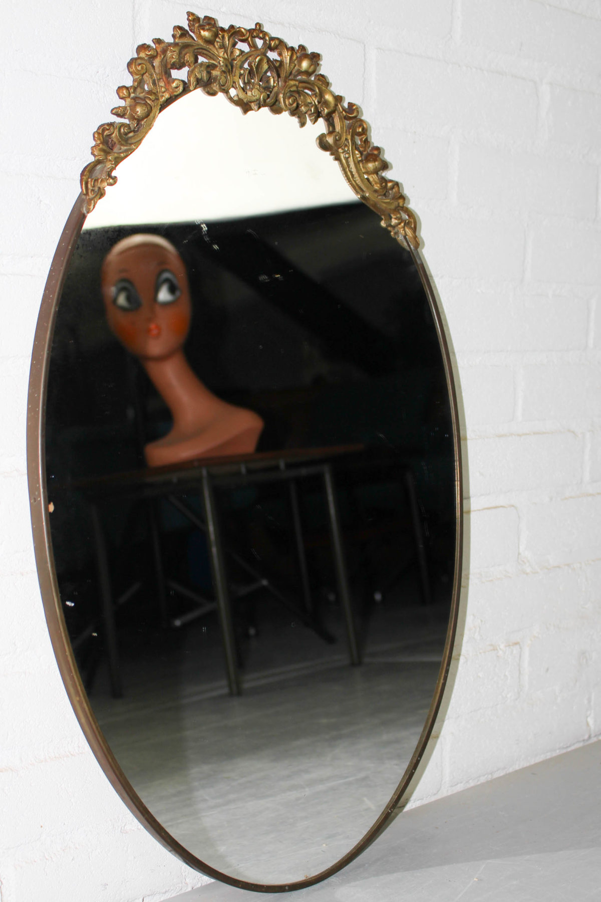 Antique oval wall mirror in brass frame with top ornament The Great Apple